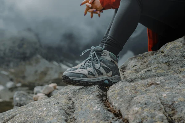 Close-up of hiking boots on rocky mountain trail
